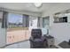 Cozy sitting area with a plush recliner and sliding glass doors with views of the water at 137 Poinsettia Ne Cir, Port Charlotte, FL 33952