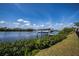 Scenic waterfront view with a boat lift and lush landscaping along the shoreline at 137 Poinsettia Ne Cir, Port Charlotte, FL 33952