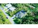 Aerial view of a private estate, featuring a screened-in pool, lush landscaping, and ample parking at 14029 Cain Ave, Port Charlotte, FL 33953