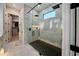 Modern bathroom featuring a glass-enclosed shower with a black rainfall shower head and marble tile at 14029 Cain Ave, Port Charlotte, FL 33953