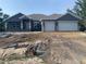 New home features a two-car garage, modern elevation, and well-lit entryway at 14583 Lillian Cir, Port Charlotte, FL 33981