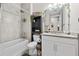 Well-lit bathroom features a shower-tub combo, modern vanity, and decorative accents at 1470 Atwater Dr, North Port, FL 34288