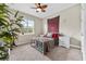 Cozy bedroom with a leaf-blade ceiling fan, ample natural light, and neutral decor at 1470 Atwater Dr, North Port, FL 34288