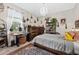 Bedroom features a rustic desk, dresser, and comfortable bed complemented by natural light at 1470 Atwater Dr, North Port, FL 34288