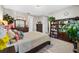 Cozy bedroom features a comfortable bed and a dark wood bookshelf filled with books and plants at 1470 Atwater Dr, North Port, FL 34288