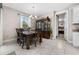 Dining room view with a wooden table, seating for six, china cabinet, and modern chandelier at 1470 Atwater Dr, North Port, FL 34288
