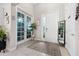 Bright and airy foyer featuring decorative glass doors, tile flooring, and ample natural light at 1470 Atwater Dr, North Port, FL 34288