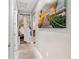 Hallway featuring tile floor, a beach-themed art piece and doorway into bedroom at 1470 Atwater Dr, North Port, FL 34288