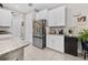 Kitchen area featuring stainless steel refrigerator, white cabinets and granite counters at 1470 Atwater Dr, North Port, FL 34288