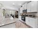 Spacious kitchen with stainless steel appliances, granite counters and view of dining room and backyard at 1470 Atwater Dr, North Port, FL 34288