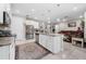 Open kitchen with a large island, granite counters, stainless steel appliances, and a view to the living room at 1470 Atwater Dr, North Port, FL 34288