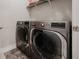 Convenient laundry room with modern appliances and a patterned rug at 1470 Atwater Dr, North Port, FL 34288