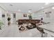 Open-concept living room with tile floors, large sectional sofa, and an abundance of natural light at 1470 Atwater Dr, North Port, FL 34288