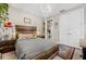Bedroom featuring a chandelier, gray bedding, and a view to closet with double doors at 1470 Atwater Dr, North Port, FL 34288