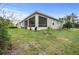 Back of the home with a screened patio, offering outdoor living space at 1470 Atwater Dr, North Port, FL 34288