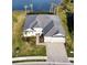 Aerial view of home with a three-car garage, nice landscaping, and brick driveway at 15155 Scarlet Oak Ct, Punta Gorda, FL 33955
