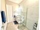 Bathroom featuring tiled floors, glass shower, white vanity and toilet at 15155 Scarlet Oak Ct, Punta Gorda, FL 33955