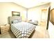 Cozy bedroom featuring neutral walls, tile floors, and natural light from the window at 15155 Scarlet Oak Ct, Punta Gorda, FL 33955