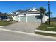 Beautiful home with three-car garage, well-maintained landscaping, and paver driveway at 15155 Scarlet Oak Ct, Punta Gorda, FL 33955