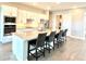 Bright open kitchen with stainless steel appliances, granite countertops, and an island with seating at 15155 Scarlet Oak Ct, Punta Gorda, FL 33955