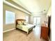 Bright main bedroom with tray ceiling, tile floors, and a sliding glass door to the outdoors at 15155 Scarlet Oak Ct, Punta Gorda, FL 33955