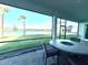 Covered outdoor living space features a stone table, chairs, and a gorgeous lake view at 15155 Scarlet Oak Ct, Punta Gorda, FL 33955