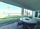Covered patio with stone table, chairs, and a gorgeous lake view at 15155 Scarlet Oak Ct, Punta Gorda, FL 33955