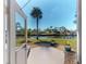 Backyard view of the canal and a private boat dock through a glass door at 18393 Hottelet Cir, Port Charlotte, FL 33948