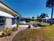 View of the landscaped backyard with a hot tub and waterfront in the distance at 18393 Hottelet Cir, Port Charlotte, FL 33948