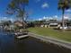 Waterfront backyard features boat dock and lush landscaping at 18393 Hottelet Cir, Port Charlotte, FL 33948