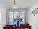 Bright dining room featuring a wooden table, chairs, and natural light through the window at 18393 Hottelet Cir, Port Charlotte, FL 33948