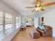 Inviting living room with wood floors, comfortable seating, and a view into the Primary bedroom at 18393 Hottelet Cir, Port Charlotte, FL 33948