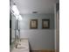 Bathroom featuring a double vanity, tiled walls, framed mirrors, and artwork at 21405 Olean Blvd # 605, Port Charlotte, FL 33952