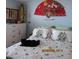 Relaxing bedroom with a patterned comforter and a cat resting on the bed at 21405 Olean Blvd # 605, Port Charlotte, FL 33952