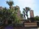 View of the exterior with mature landscaping and signage at the East Promenades complex at 21405 Olean Blvd # 605, Port Charlotte, FL 33952