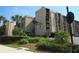 Exterior of the building with lush landscaping, signage and multiple units with screened in porches at 21405 Olean Blvd # 605, Port Charlotte, FL 33952