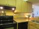 Cozy kitchen area featuring modern appliances, light cabinetry, and functional layout for efficient cooking experiences at 21405 Olean Blvd # 605, Port Charlotte, FL 33952