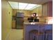 Efficient kitchen layout with stainless steel appliances, a breakfast bar, and ample counter space for meal preparation at 21405 Olean Blvd # 605, Port Charlotte, FL 33952