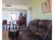 Cozy living room featuring comfortable brown leather seating and dining area at 21405 Olean Blvd # 605, Port Charlotte, FL 33952