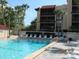 Community pool with lounge chairs, tables, and a building in the background at 21405 Olean Blvd # 605, Port Charlotte, FL 33952