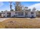 Charming single-story home with white siding and a well-manicured front lawn at 215 Washington Ave, Englewood, FL 34223