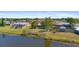 Aerial view of a single-story home situated on a large lot with mature trees and water views at 2255 Easy St, Port Charlotte, FL 33952