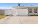 Backyard view showing a white gate, side of the home, and concrete patio at 2255 Easy St, Port Charlotte, FL 33952