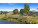 Large backyard featuring mature trees and a pond view at 2255 Easy St, Port Charlotte, FL 33952