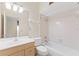 Bright bathroom features a single sink vanity, toilet, and a shower-tub combo with white tile surround at 2255 Easy St, Port Charlotte, FL 33952