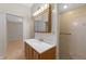 Bathroom with wood vanity, updated shower and vanity lighting, and a walk-in shower with glass door at 2255 Easy St, Port Charlotte, FL 33952