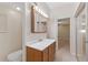 Bright bathroom featuring a wood vanity with white countertop and a sliding glass door shower entrance at 2255 Easy St, Port Charlotte, FL 33952