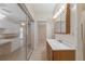 Bathroom boasts updated shower, wooden vanity and lighting, with access to the lanai, and bedroom at 2255 Easy St, Port Charlotte, FL 33952
