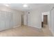 Bedroom featuring a closet, ceiling fan, new floors and access to bathroom and hallway at 2255 Easy St, Port Charlotte, FL 33952