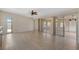 Open bonus room features light-colored flooring, and sliding glass doors that open to the outdoors at 2255 Easy St, Port Charlotte, FL 33952